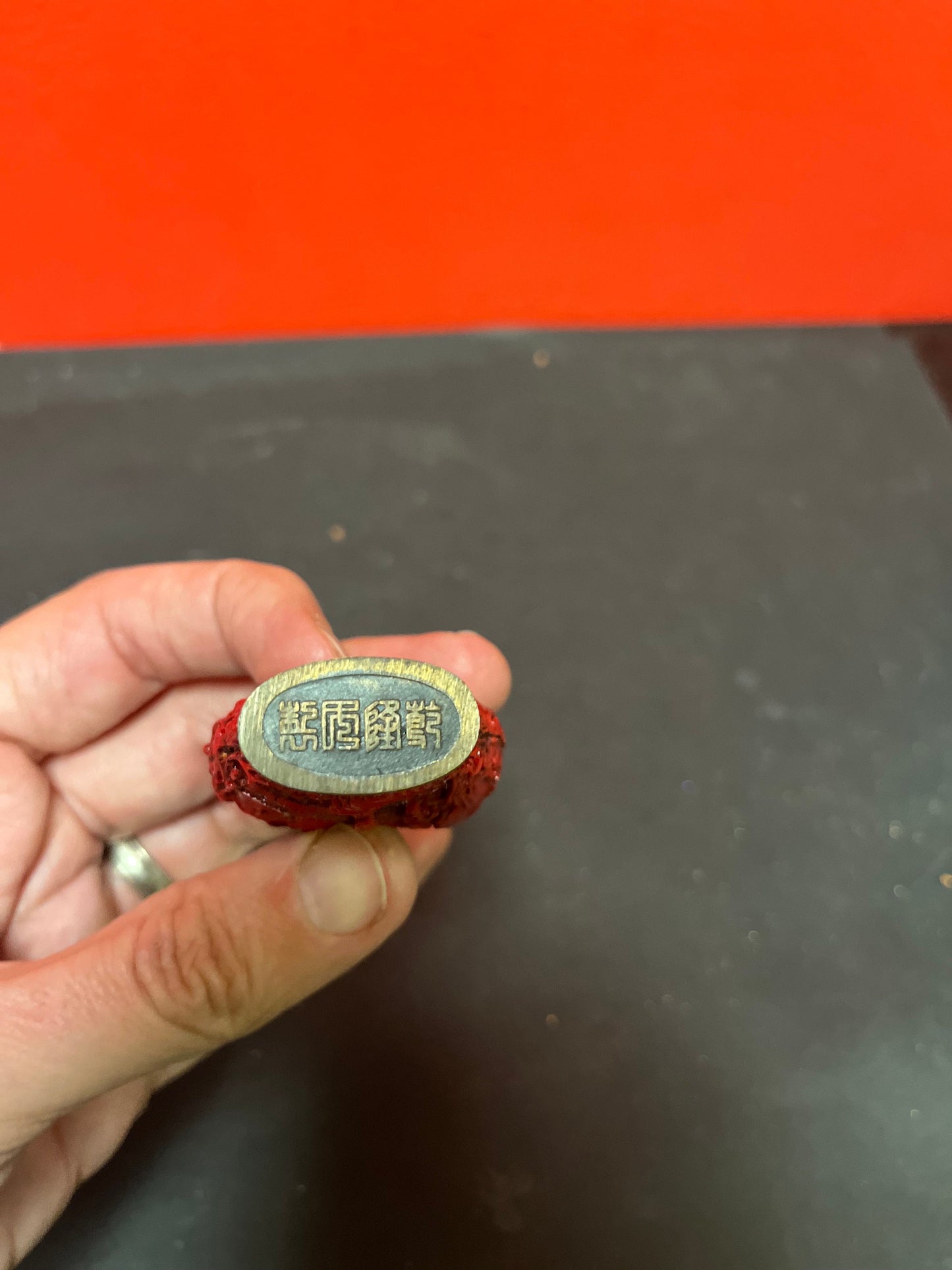 A  Chinese 3 inch high well detailed cinnabar  snuff bottle  great condition, but top is stuck.  low price