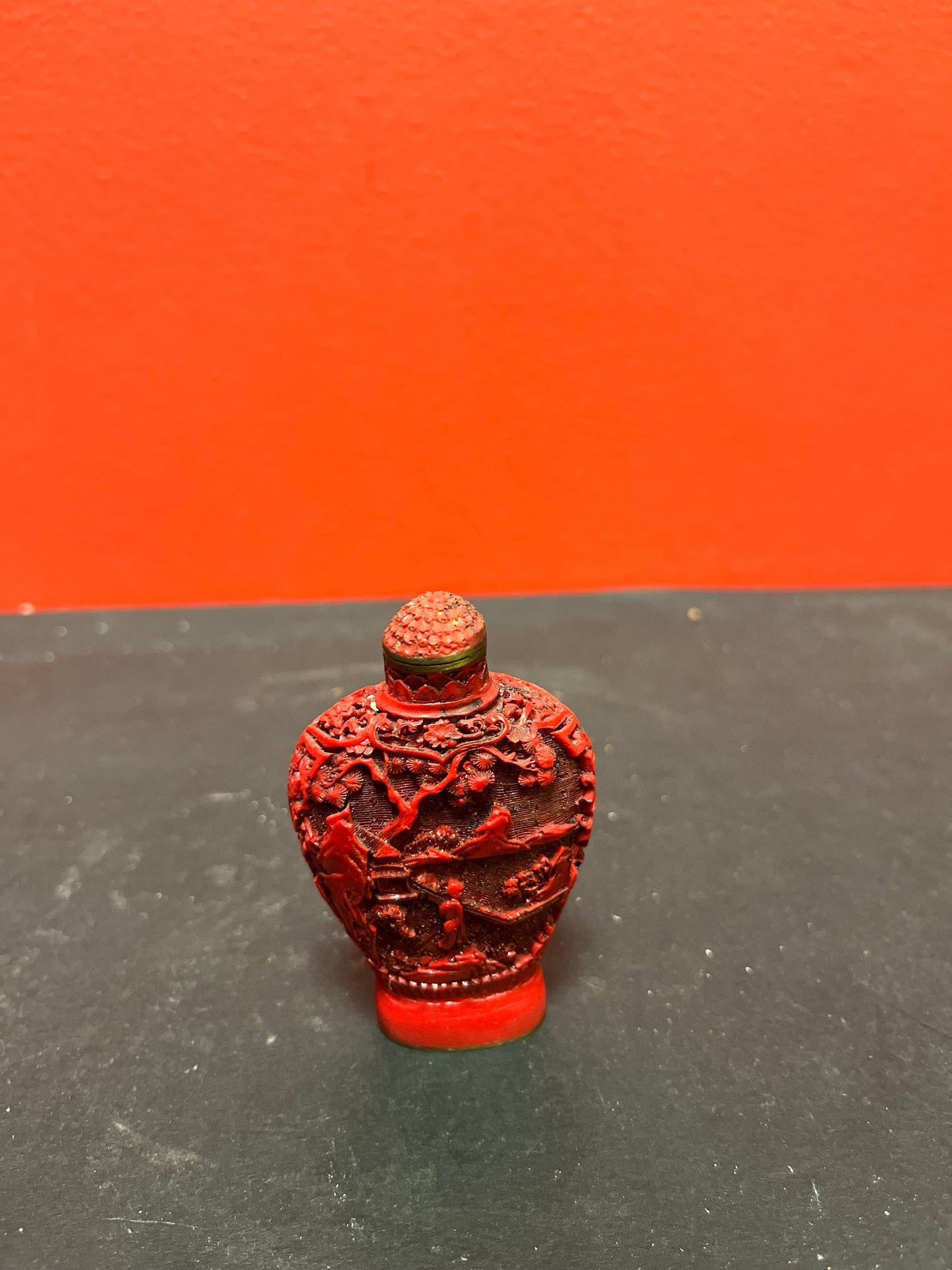A  Chinese 3 inch high well detailed cinnabar  snuff bottle  great condition, but top is stuck.  low price