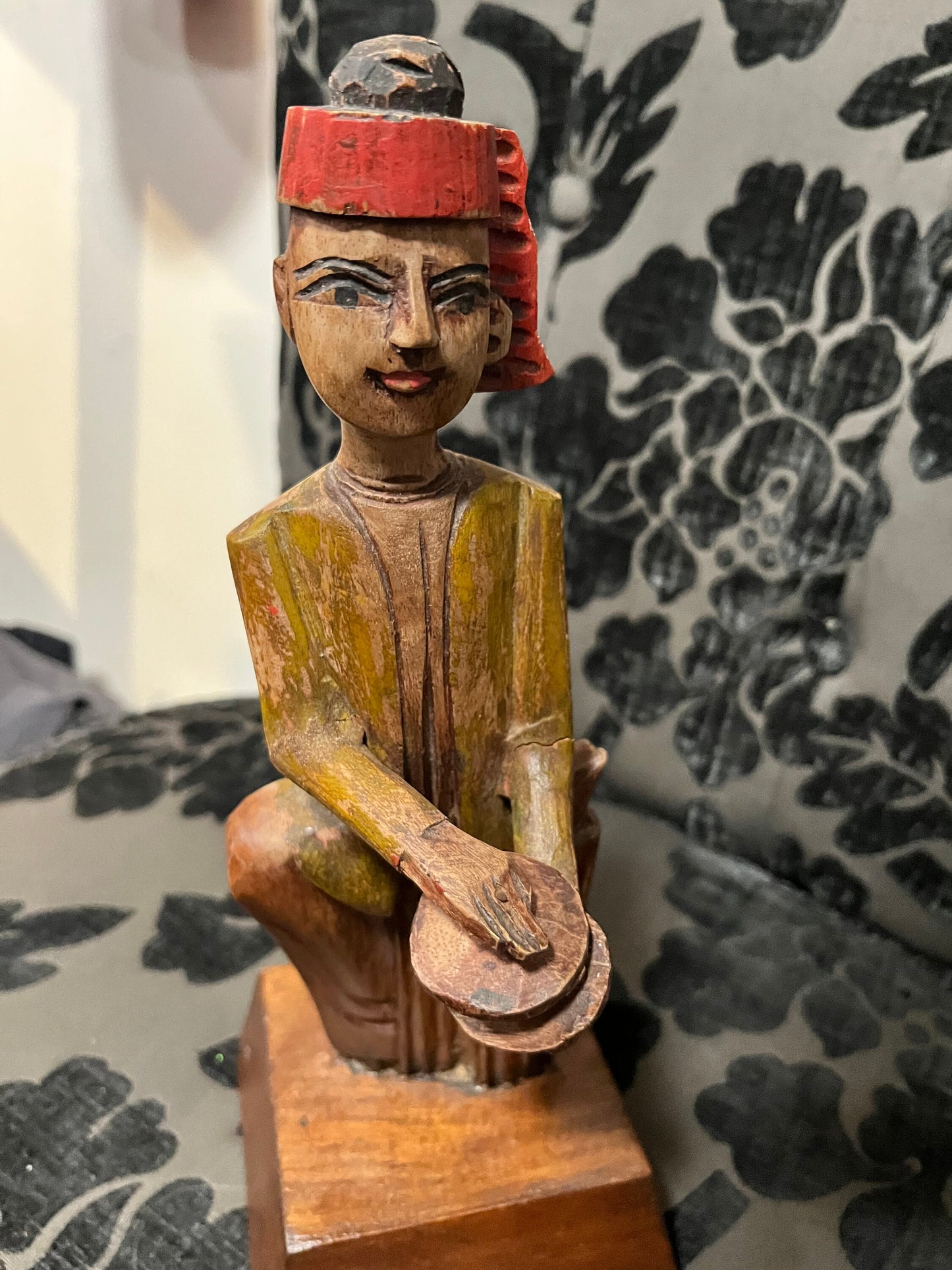 A 11 inch south east wooden statue  stand or hang