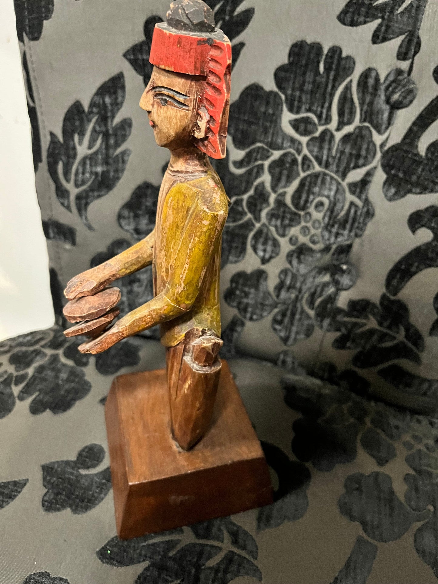 A 11 inch south east wooden statue  stand or hang