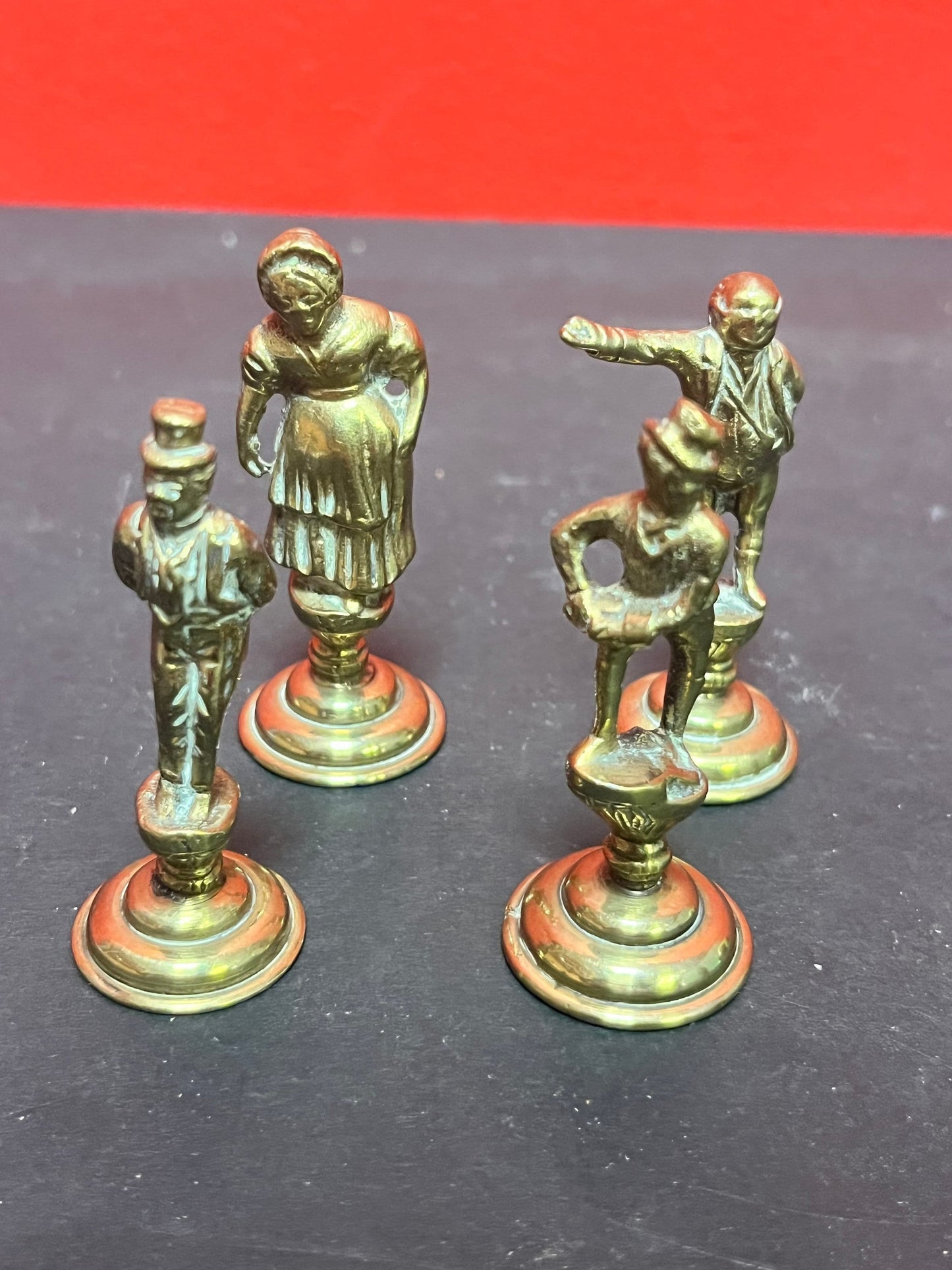 Lovely antique set of four brass Dickens character pipe  tampers  wonderful set in great condition and 2. 5 inches high each.
