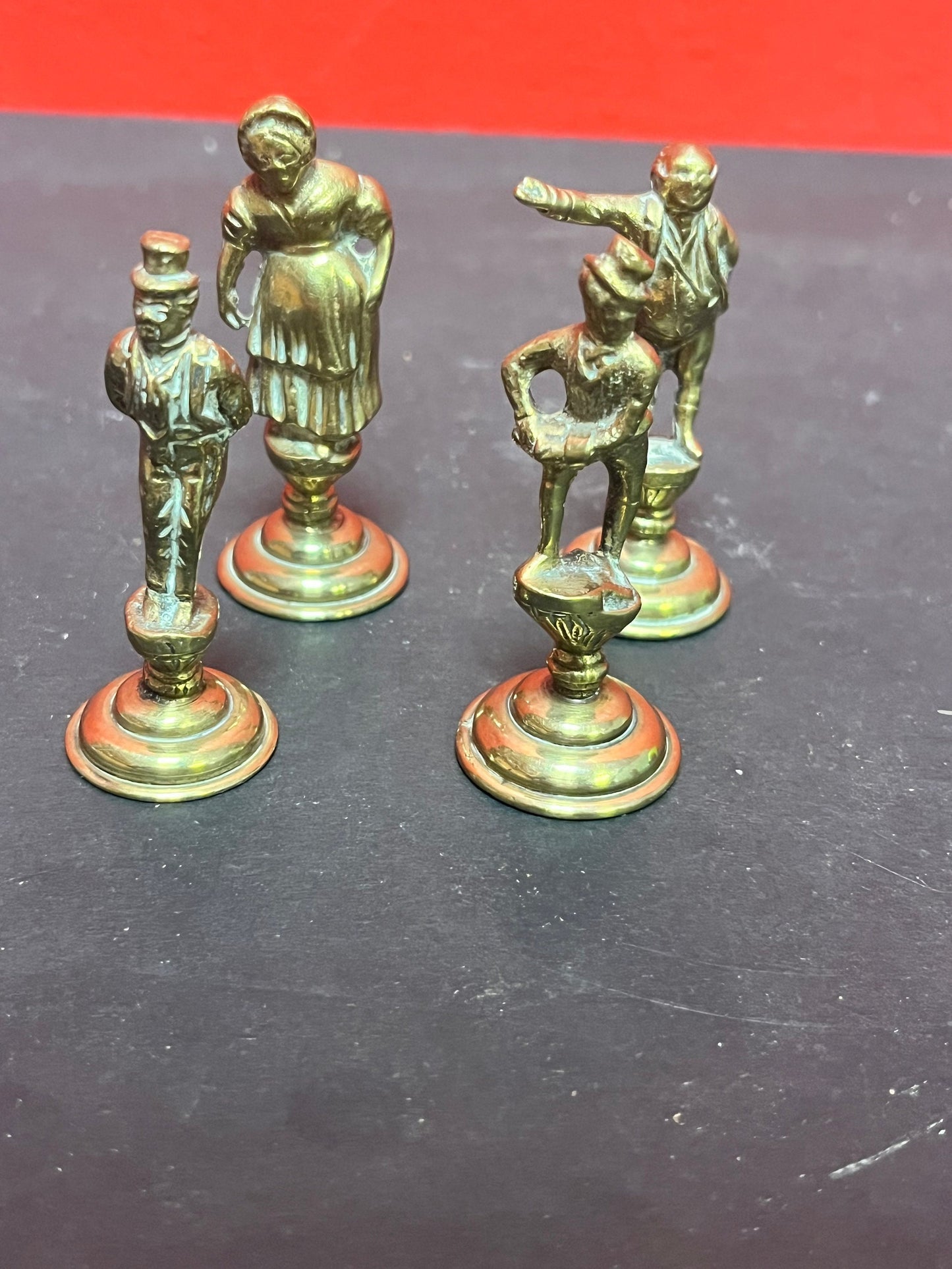 Lovely antique set of four brass Dickens character pipe  tampers  wonderful set in great condition and 2. 5 inches high each.
