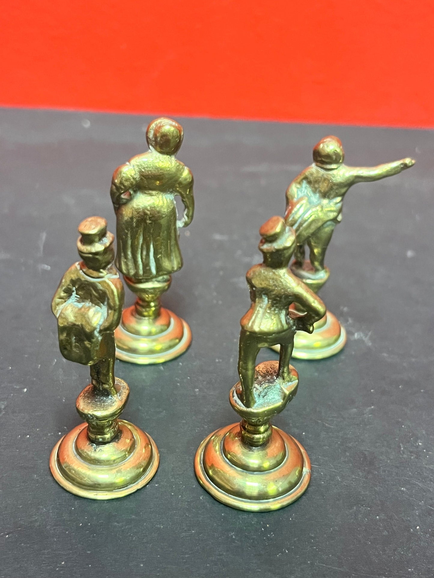 Lovely antique set of four brass Dickens character pipe  tampers  wonderful set in great condition and 2. 5 inches high each.