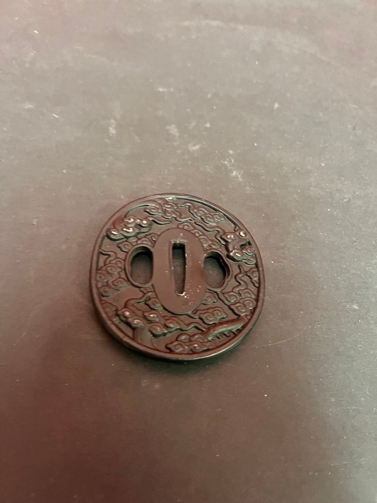 Lovely antique Japanese bronze and GILT tsuba set in stone - stone isnt perfect see photos  2.5 inches  great value - perfect paperweight