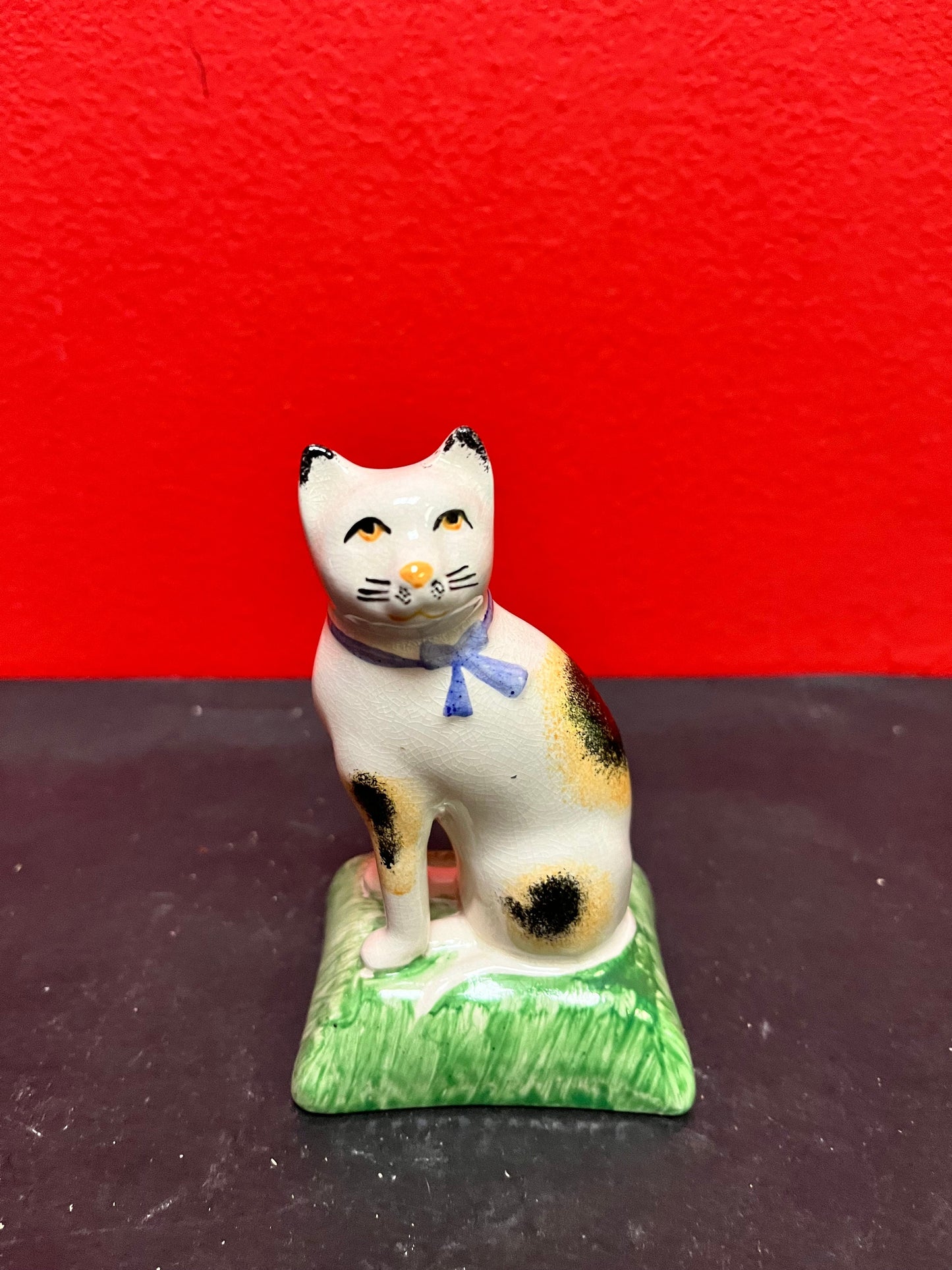 Lovely antique 4 inch high English Staffordshire cat on pillow