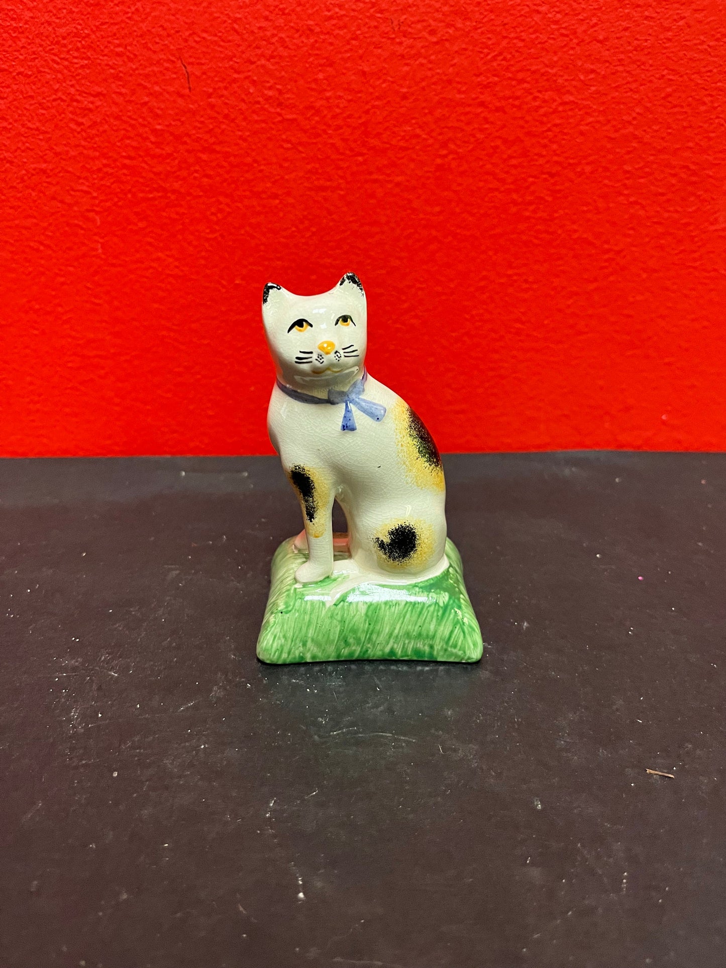Lovely antique 4 inch high English Staffordshire cat on pillow