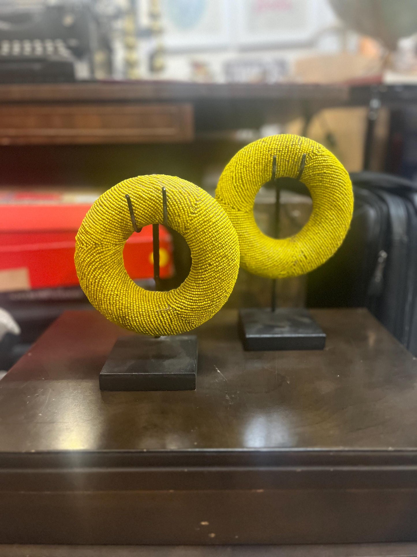 Pair of stunning museum quality antique Zulu wedding bronze and beaded ceremonial bracelets on stands heavy 5 and 6 inches wide