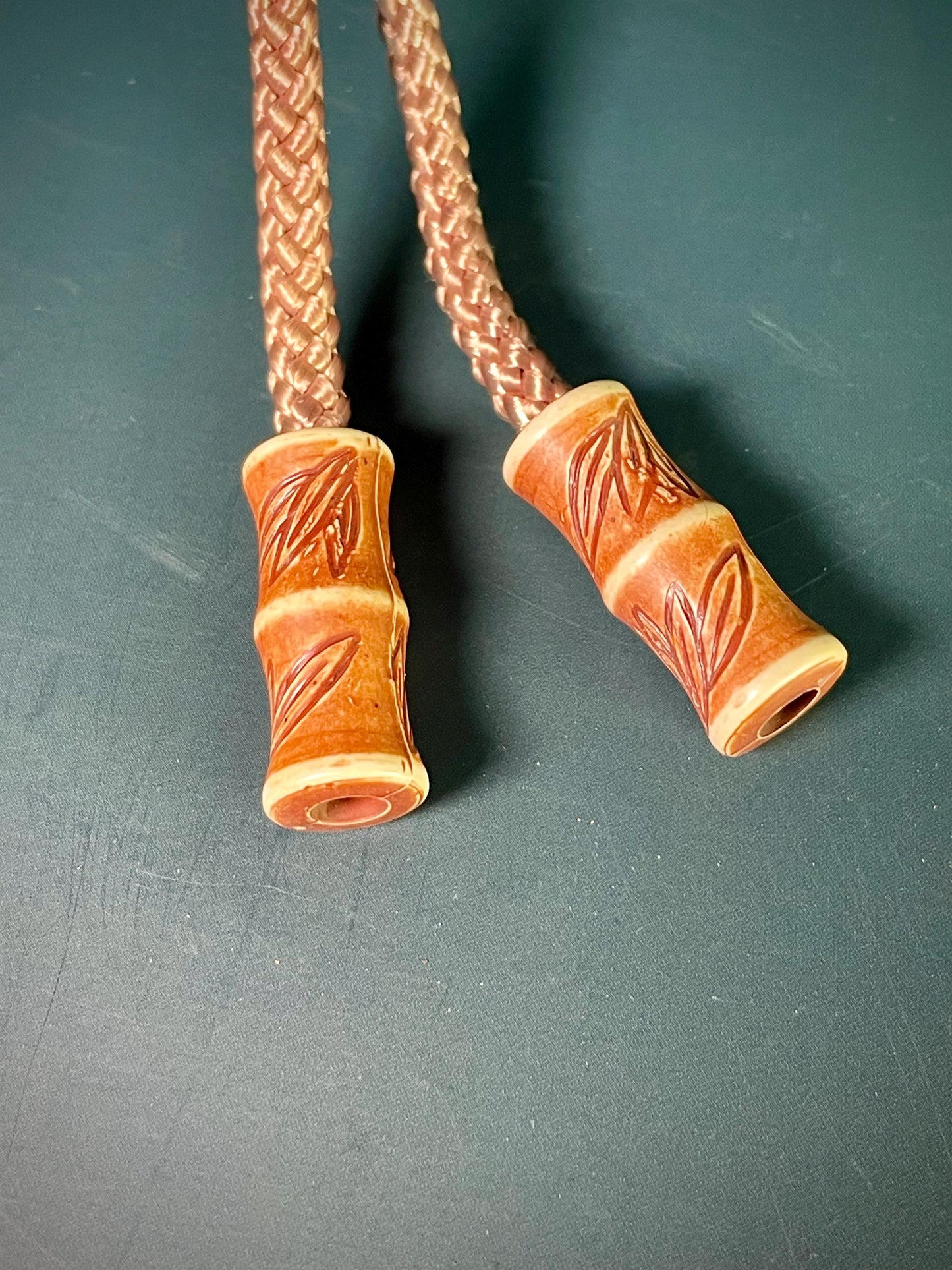 38 Bolo Tie with Carved Face and Accent Beads