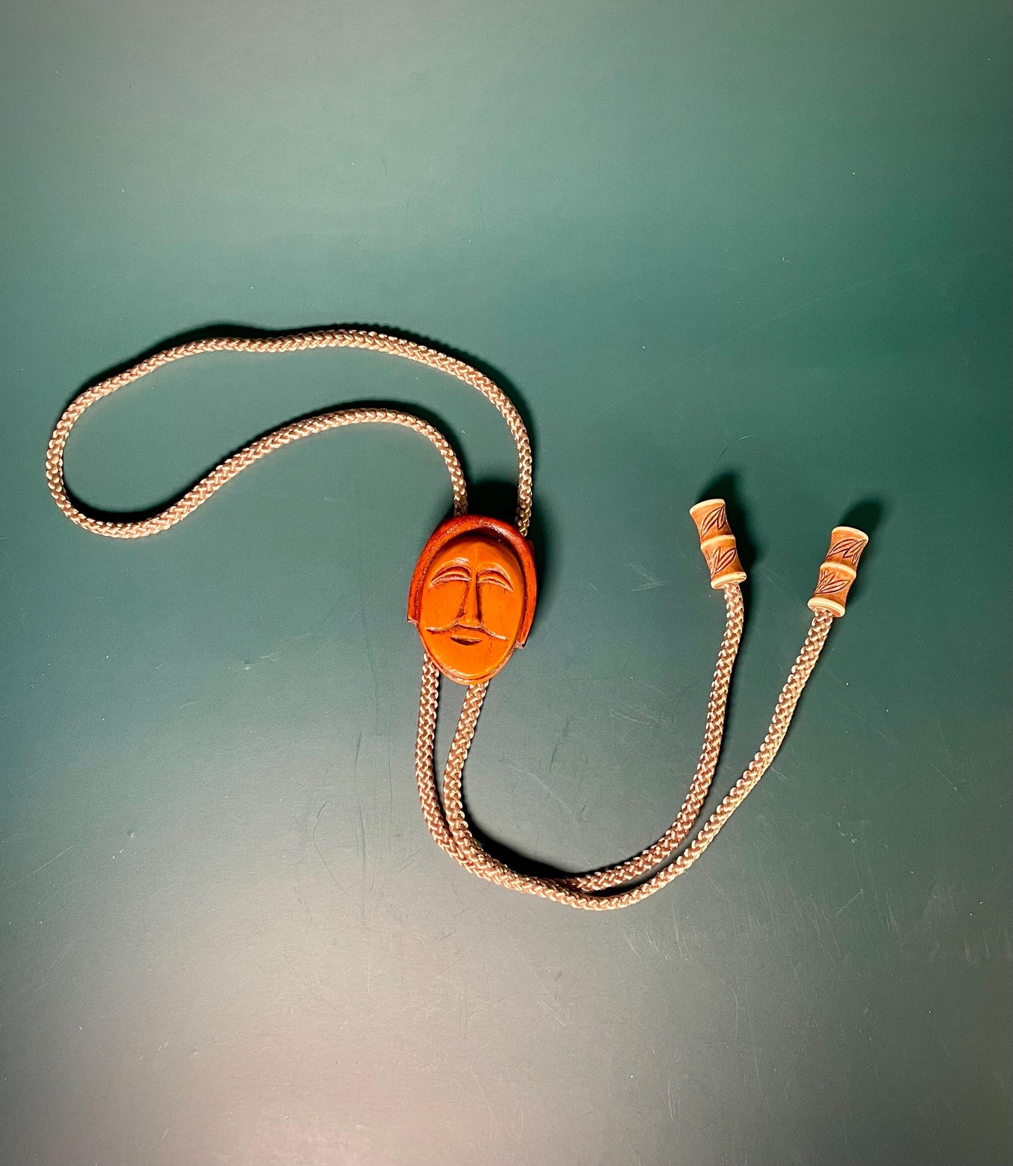 38 Bolo Tie with Carved Face and Accent Beads