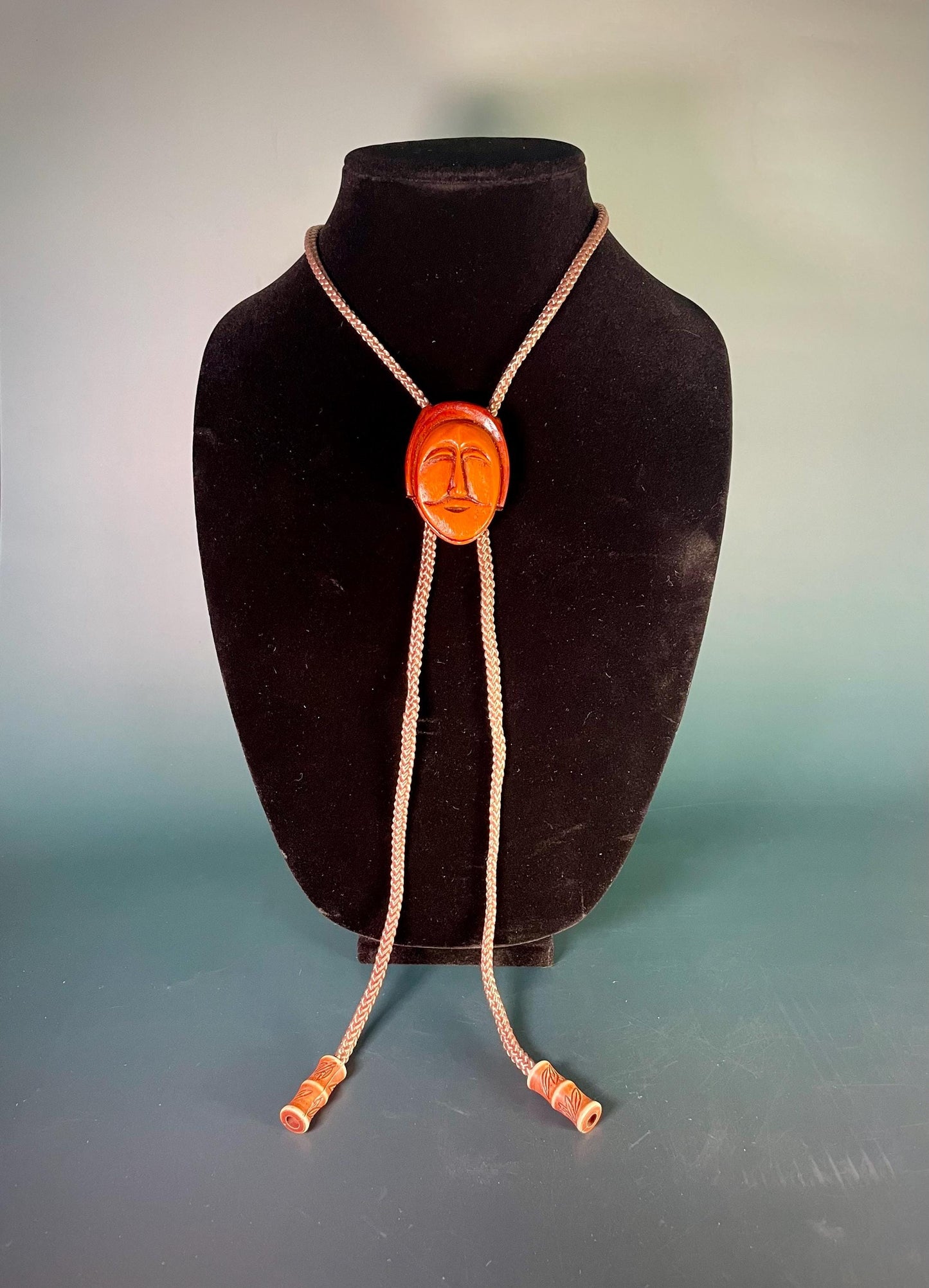 38 Bolo Tie with Carved Face and Accent Beads