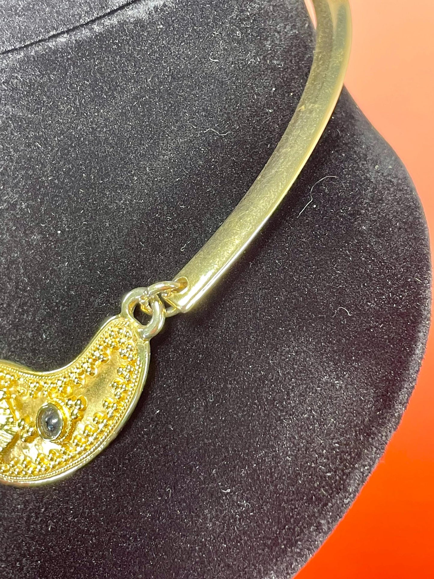 Gold-Tone Collar Necklace with Textured Details & Black Stone Accents