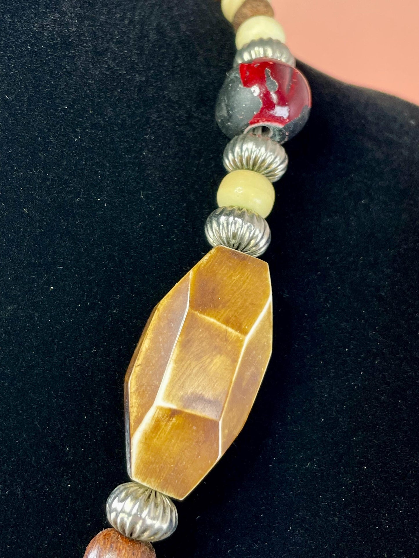 Lovely Beaded necklace  approximately 22 inches long  2.25 inch Metal Pendant