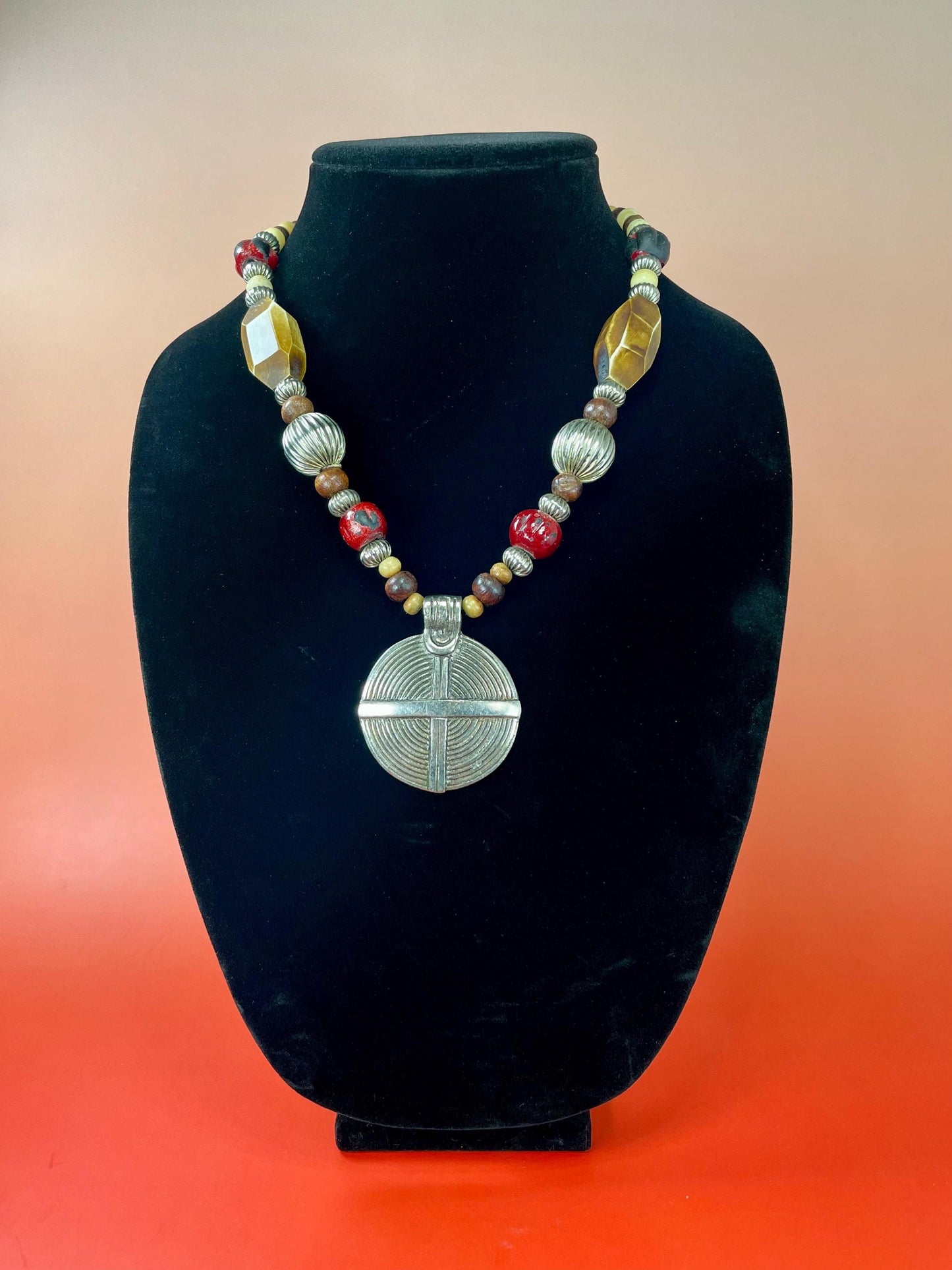 Lovely Beaded necklace  approximately 22 inches long  2.25 inch Metal Pendant