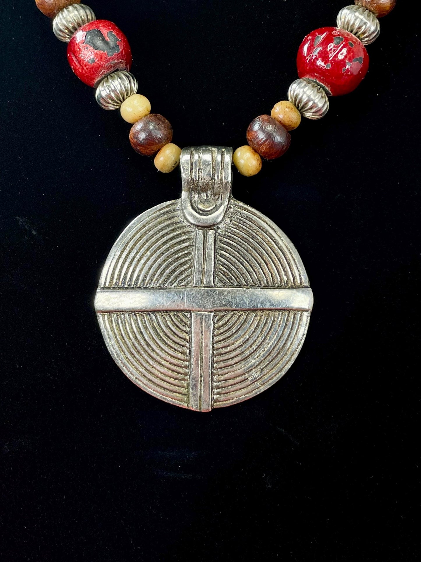 Lovely Beaded necklace  approximately 22 inches long  2.25 inch Metal Pendant