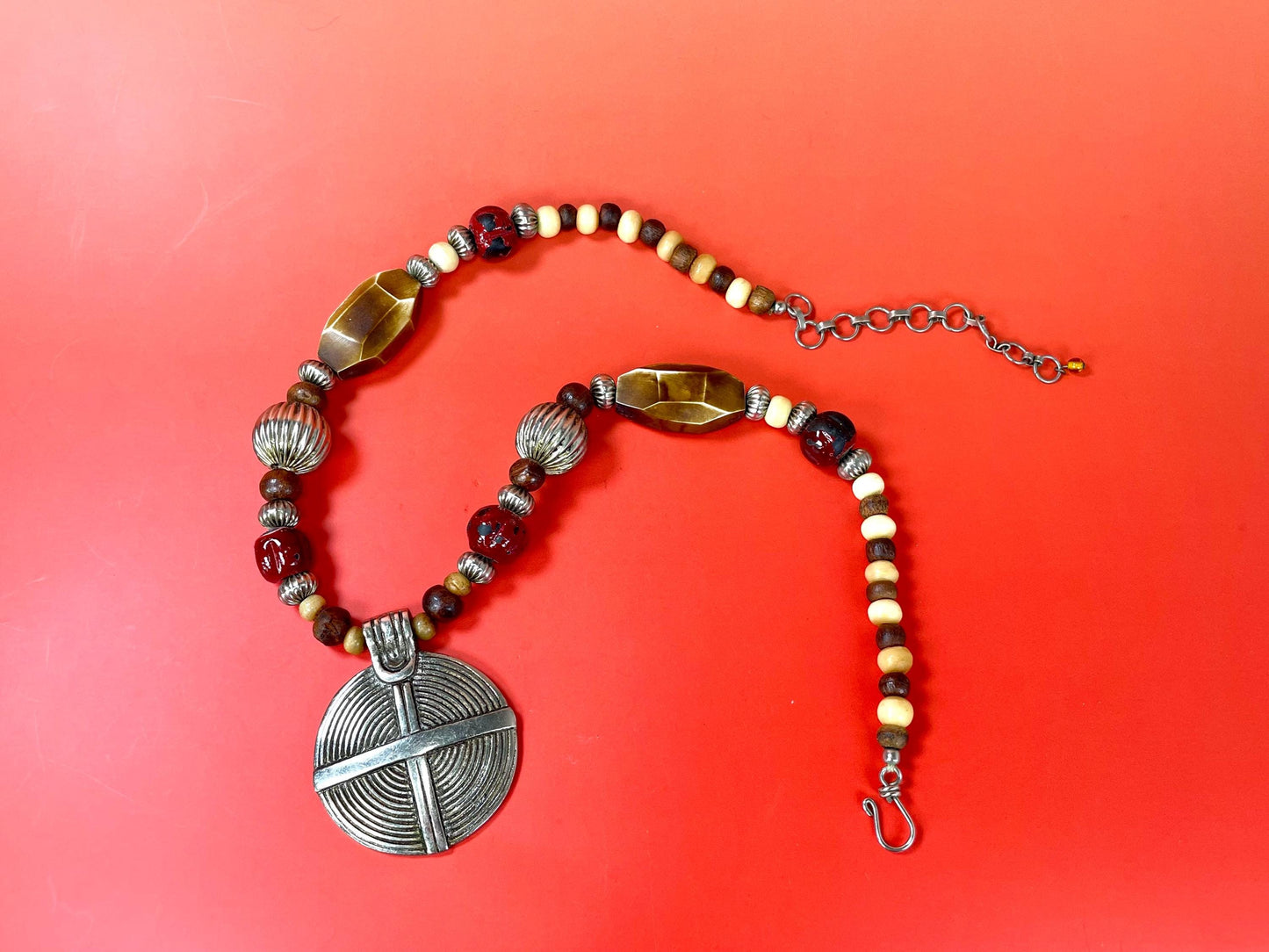 Lovely Beaded necklace  approximately 22 inches long  2.25 inch Metal Pendant