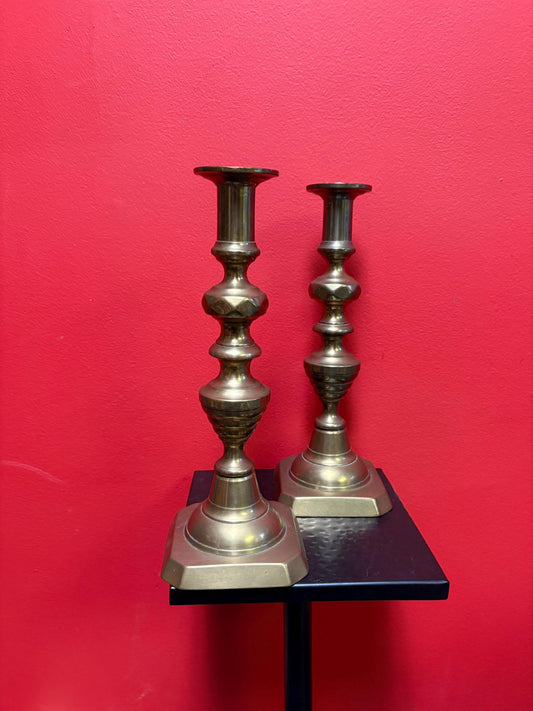 Beautiful 11 inch tall antique brass candlesticks with the original lifters  good condition and stable