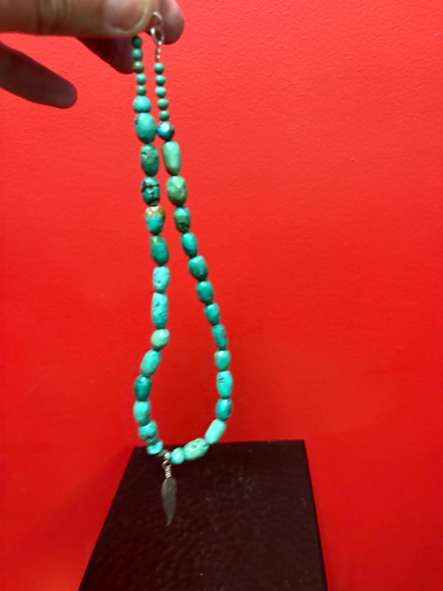 Beautiful approximately 14 inch long turquoise necklace with silver feather charm