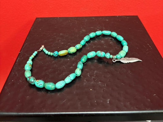 Beautiful approximately 14 inch long turquoise necklace with silver feather charm