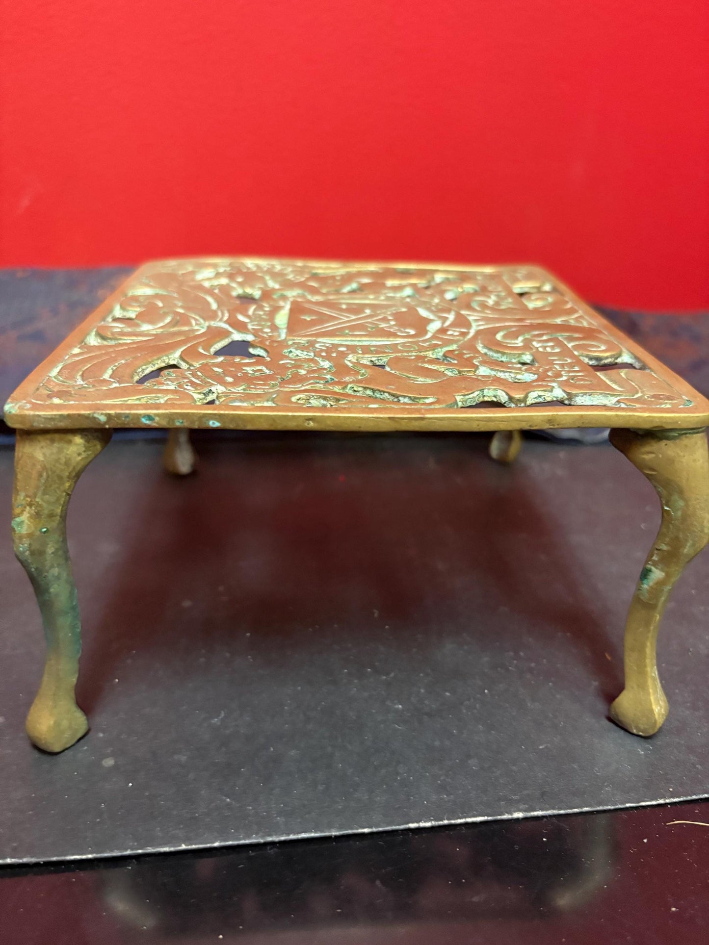 Lovely antique brass royalty themed trivet 6 x 3“ high in great condition with amazing patina