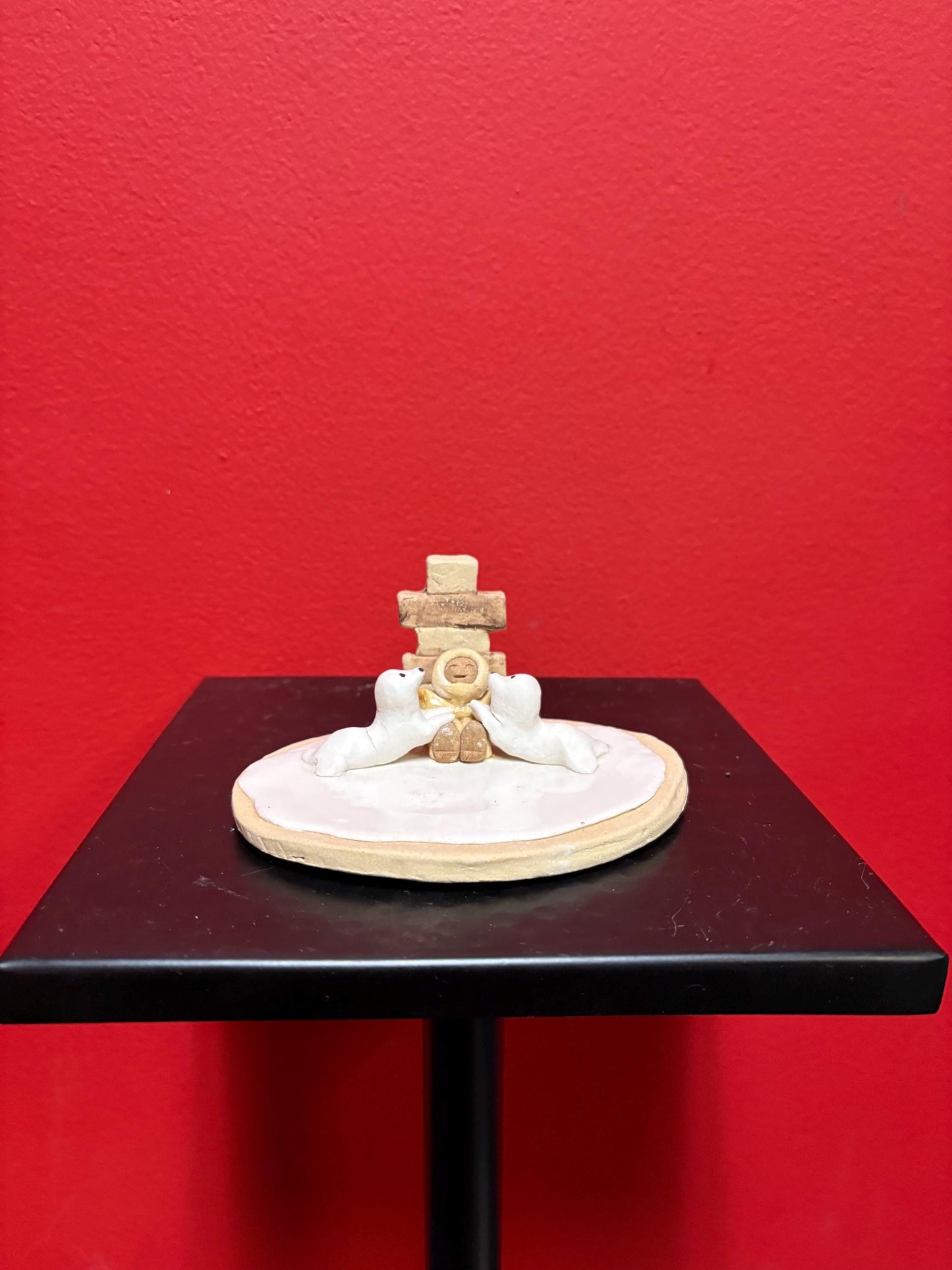 Beautiful indigenous statue of an Eskimo and seals and an Inukshuk  5 x 2 1/2“ high signed  2 available