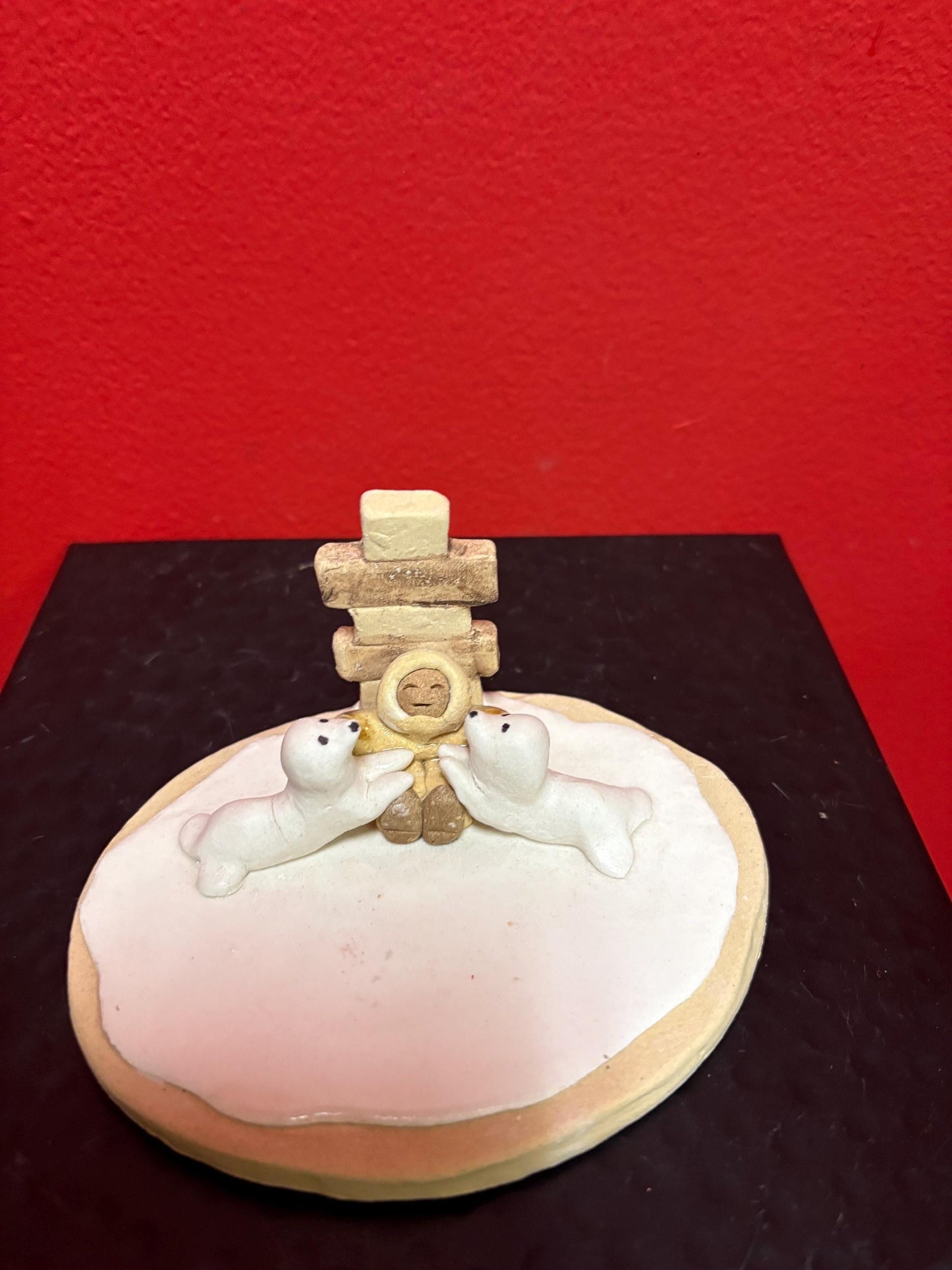 Beautiful indigenous statue of an Eskimo and seals and an Inukshuk  5 x 2 1/2“ high signed  2 available