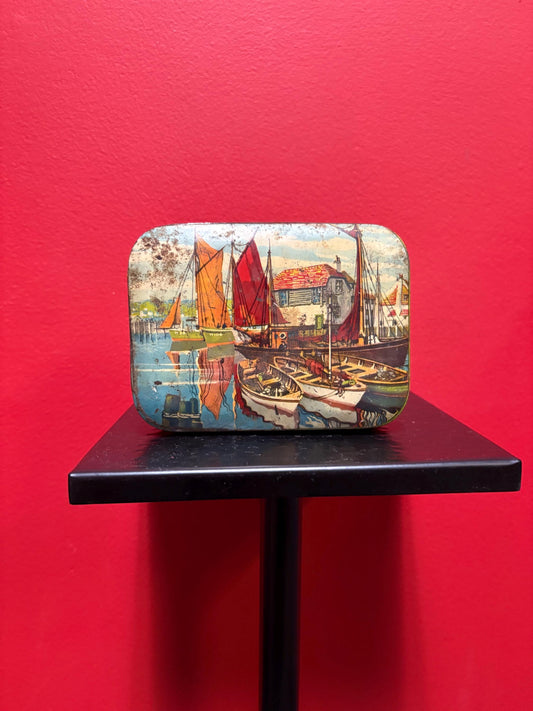 Lovely 5 1/2 x 4 x 1.25 high antique toffee tin with boats scene  old used condition