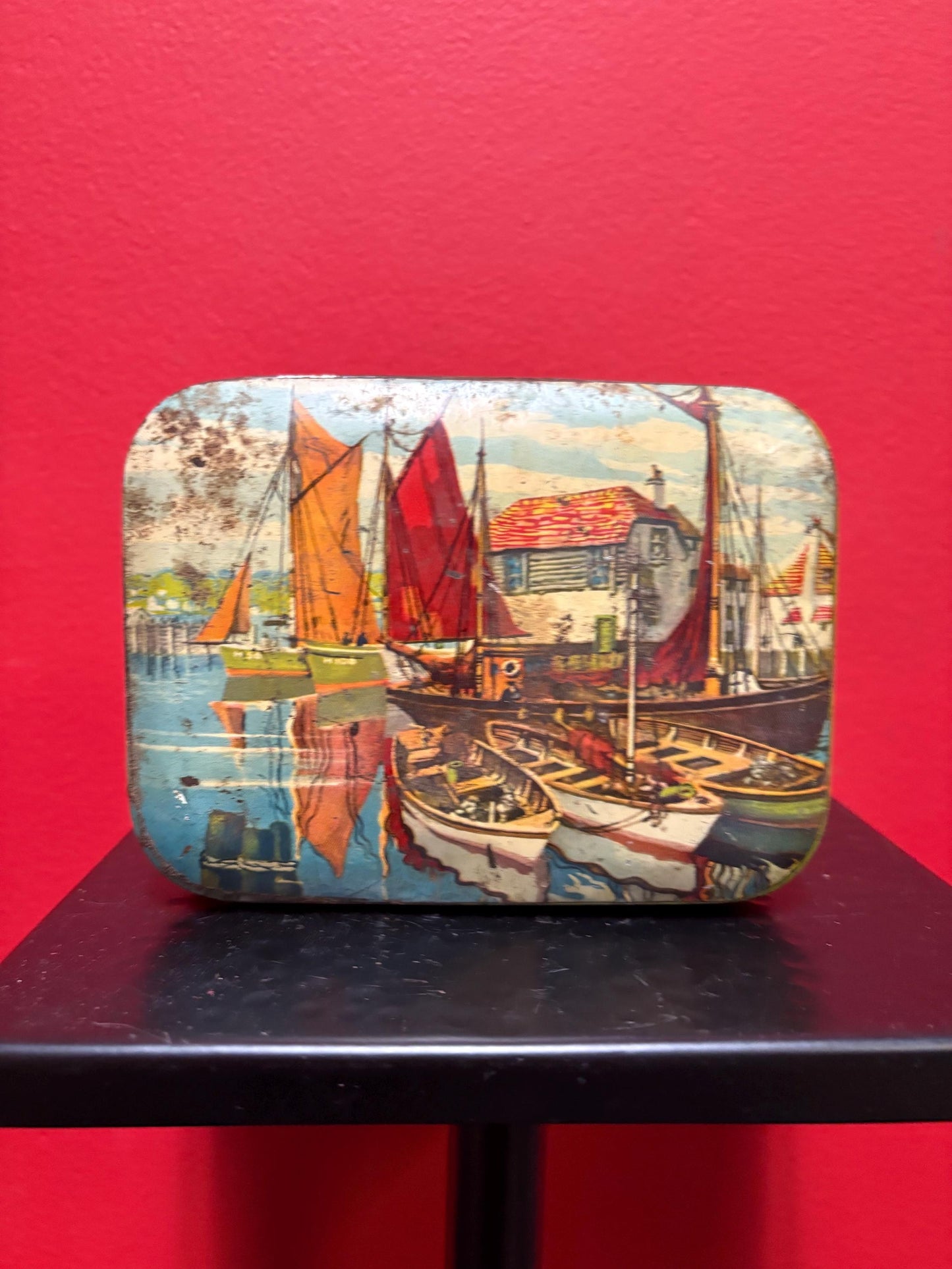 Lovely 5 1/2 x 4 x 1.25 high antique toffee tin with boats scene  old used condition